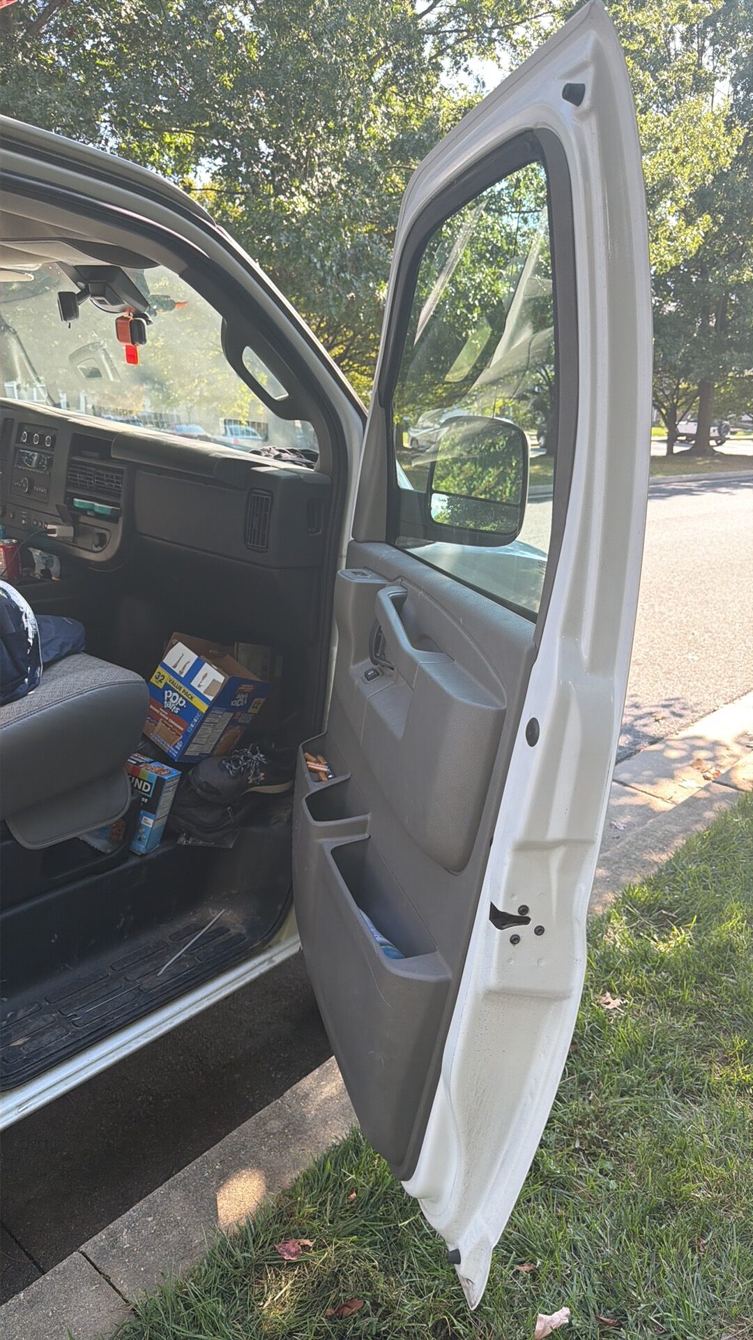 Open passenger door and front cabin of the Chevrolet Express following the Owings Mills lockout job