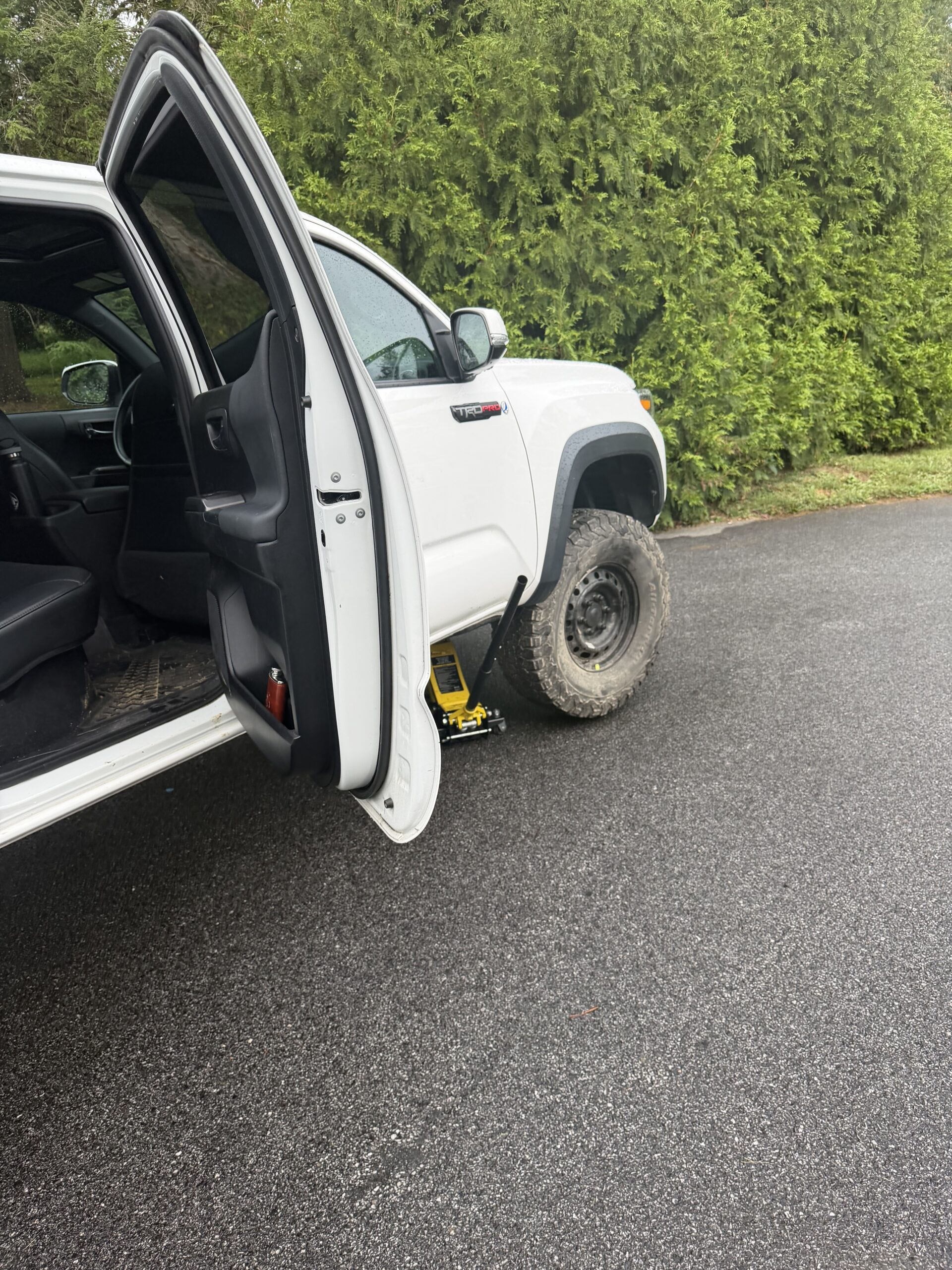 Toyota Tacoma with a steel replacement wheel fitted at the front during the Garrison tire change