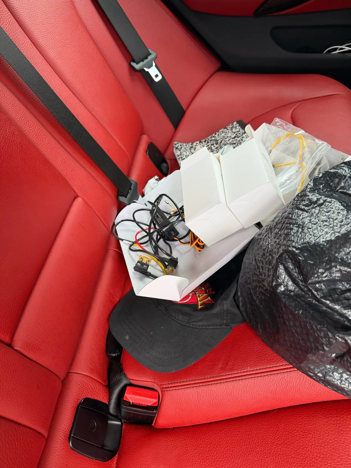 Dash camera installation components placed on the rear seat of a 2019 BMW 430i Gran Coupe in Glen Burnie