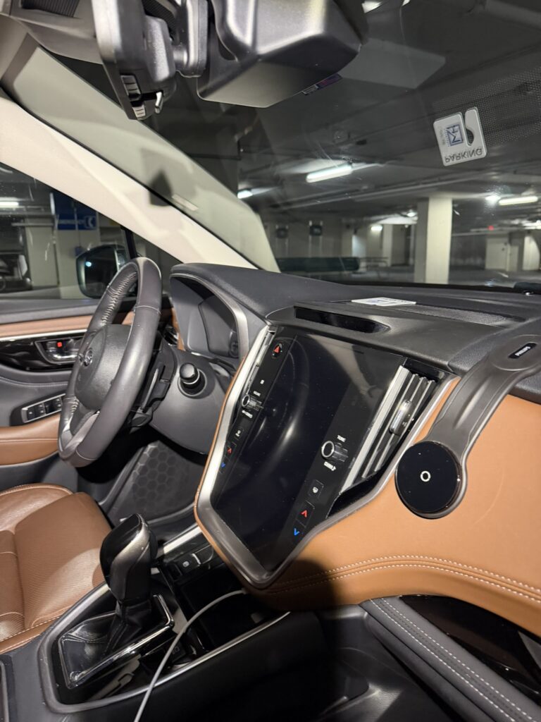 Subaru Outback Touring dashboard, centre touchscreen and tan interior viewed from the passenger side.