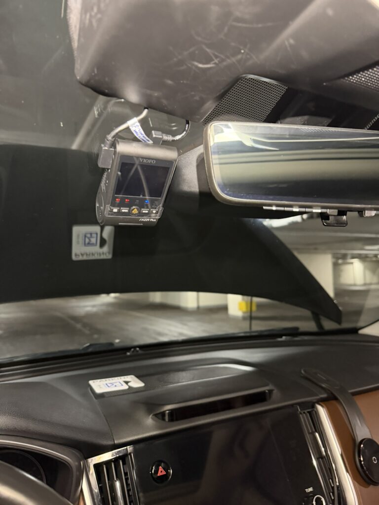 VIOFO A229 Plus mounted beside the Subaru Outback rear-view mirror, with cables entering the upper trim.